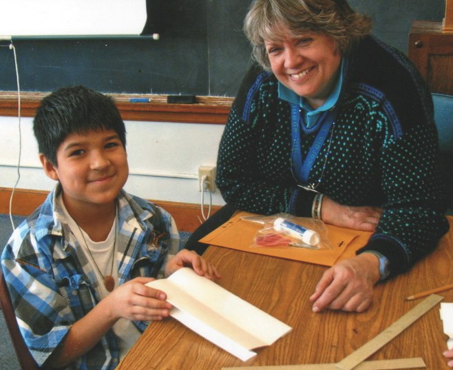 Fifth grade teacher Denise Anderson readies the necessary supplies for a book project. 