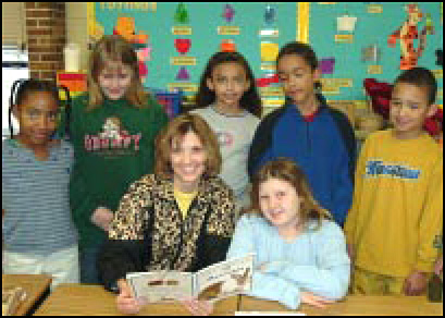 Tonya Dexter, third grade bilingual teacher, reads a story to a group of her students